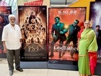Jayam Ravi and his brother Mohan Raja's parents pose in front of their film posters.