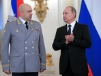 Russian President Vladimir Putin (right) applauds Col. Gen. Sergei Surovikin during an awards ceremony for troops who fought in Syria, in Moscow.&nbsp;