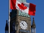 Canada's Dependent Work Visa: A Canada flag flies in front of the Peace Tower on Parliament Hill in Ottawa, Ontario. Canada's Dependent Work Visa: A Canada flag flies in front of the Peace Tower on Parliament Hill in Ottawa, Ontario.