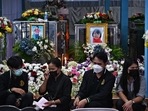 Relatives sit in front of the coffins of victims of the nursery mass shooting at Wat Si Uthai temple in Thailand's northeastern Nong Bua Lam Phu province on October 8, 2022. (Photo by Lillian SUWANRUMPHA/AFP) Relatives sit in front of the coffins of victims of the nursery mass shooting at Wat Si Uthai temple in Thailand's northeastern Nong Bua Lam Phu province on October 8, 2022. (Photo by Lillian SUWANRUMPHA/AFP)