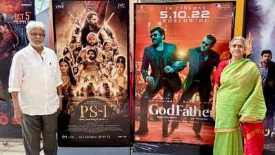 Jayam Ravi and his brother Mohan Raja's parents pose in front of their film posters.
