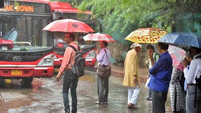 Commuters out in the rain at the DTC Mehrauli Bus Terminal in New Delhi, India, on Saturday, October 8, 2022. (Photo by Raj K Raj/ Hindustan Times) Commuters out in the rain at the DTC Mehrauli Bus Terminal in New Delhi, India, on Saturday, October 8, 2022. (Photo by Raj K Raj/ Hindustan Times)