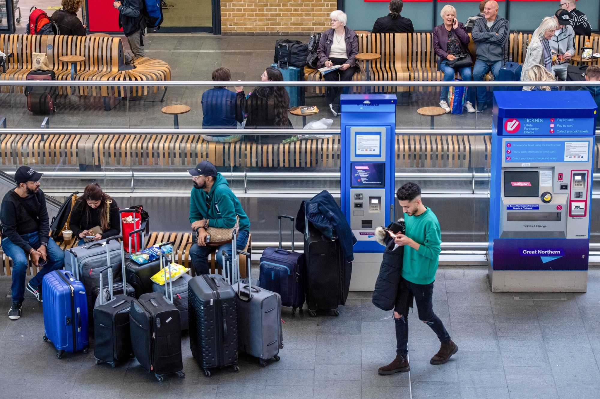 Rail passengers wait for trains next to ticket booths during a national rail strike at London King's Cross railway station in London on October 5. (Bloomberg) Rail passengers wait for trains next to ticket booths during a national rail strike at London King's Cross railway station in London on October 5. (Bloomberg)