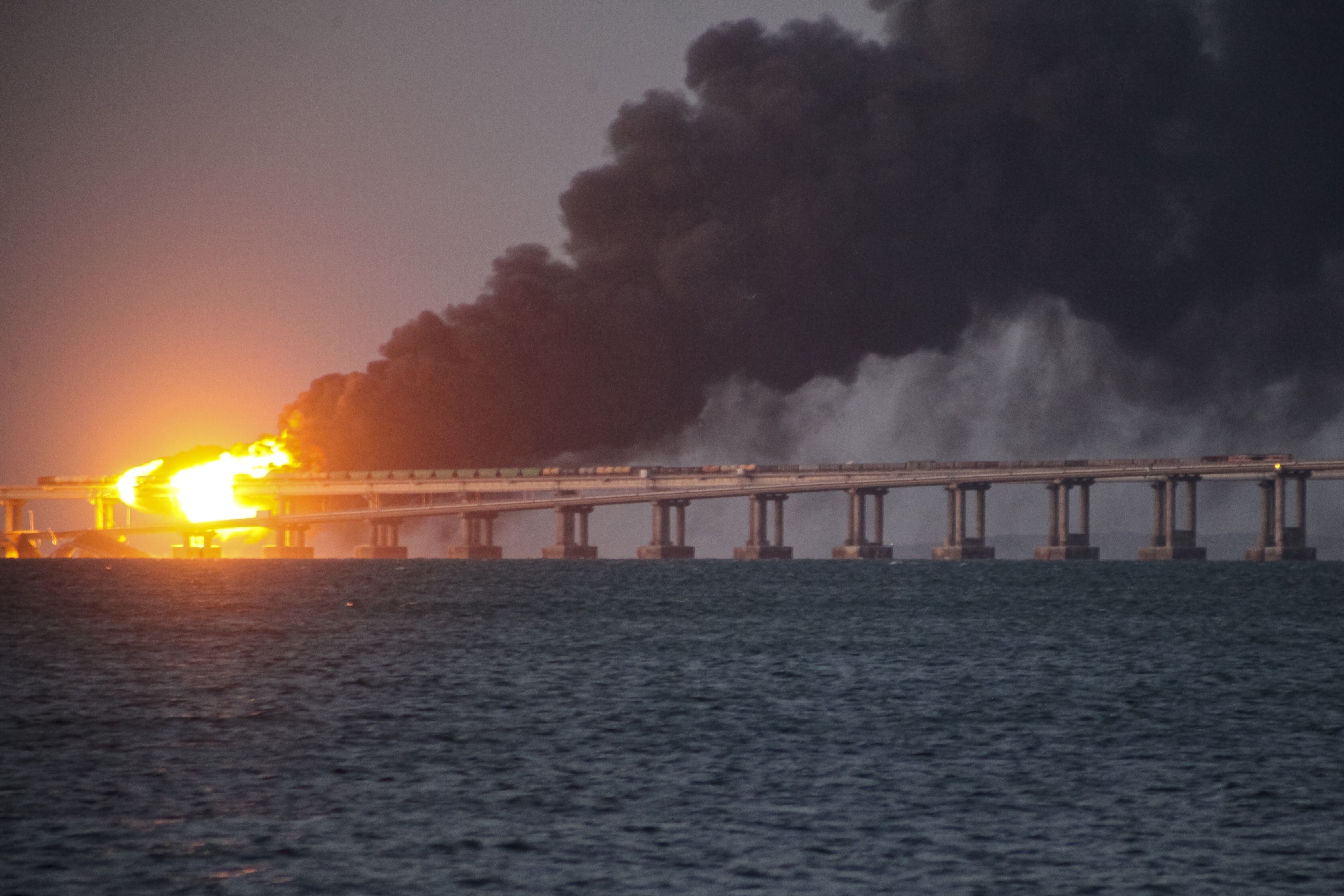 Flame and smoke rise from Crimean Bridge connecting Russian mainland and Crimean Peninsula over the Kerch Strait, in Kerch, Crimea, Saturday, October 8, 2022. (AP Photo) Flame and smoke rise from Crimean Bridge connecting Russian mainland and Crimean Peninsula over the Kerch Strait, in Kerch, Crimea, Saturday, October 8, 2022. (AP Photo)