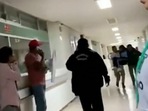 Screengrab from viral video on Twitter of a chaotic scene as parents and elders carry school children in a hospital hallway. (Twitter) Screengrab from viral video on Twitter of a chaotic scene as parents and elders carry school children in a hospital hallway. (Twitter)