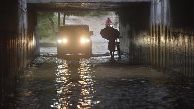 Commuters wade through a heavily waterlogged stretch in Noida on Sunday. (Sunil Ghosh/ HT) Commuters wade through a heavily waterlogged stretch in Noida on Sunday. (Sunil Ghosh/ HT)