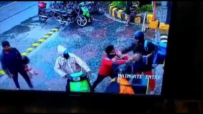 Screenshot from viral video of CCTV footage of clash that broke out between a delivery executive and a private security guard of a housing society in Noida. (ANI) Screenshot from viral video of CCTV footage of clash that broke out between a delivery executive and a private security guard of a housing society in Noida. (ANI)