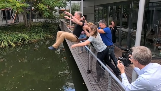 The image, taken from the video posted online, shows Svante P??bo's colleagues throwing him in a pond to celebrate his Nobel Prize win.&nbsp;(Instagram/@nobelprize_org)