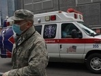 US Military: An ambulance drives by a US Army National Guards member. US Military: An ambulance drives by a US Army National Guards member.
