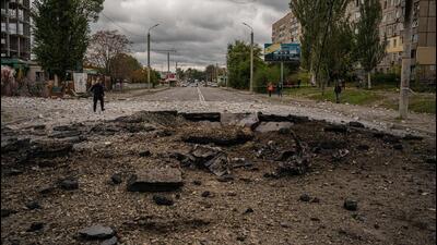 A policeman walks past a crater following a Russian airstrike in Ukraine on Monday. (AFP Photo) A policeman walks past a crater following a Russian airstrike in Ukraine on Monday. (AFP Photo)