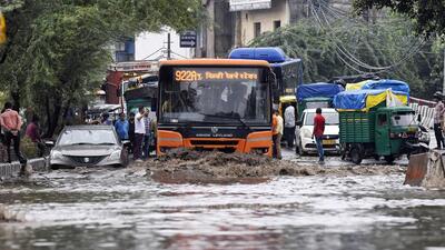 Vehicles wade through a waterlogged road in New Delhi. (ANI)