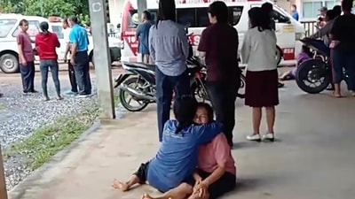 Thailand Daycare Centre Shooting: A distraught woman is comforted outside the site of an attack at a daycare canter, (AP) Thailand Daycare Centre Shooting: A distraught woman is comforted outside the site of an attack at a daycare canter, (AP)