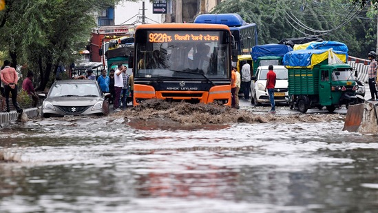 Vehicles wade through a waterlogged road following heavy rainfall, in New Delhi. (ANI Photo)