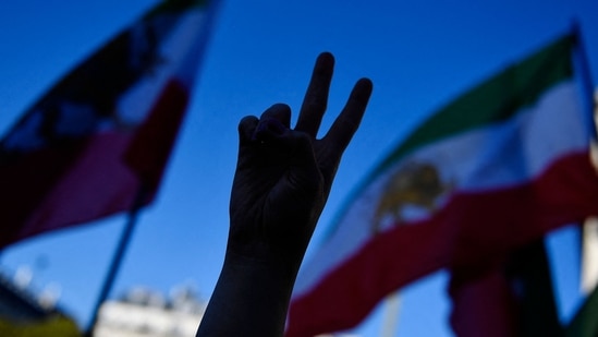 Iran Anti-Hijab Protests: Demonstrator gestures a peace sign during a rally.(AFP)