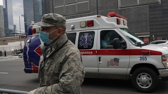 US Military: An ambulance drives by a US Army National Guards member.(AFP)