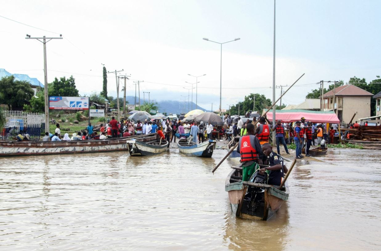 An estimated 85 people were taking the overloaded boat on Friday when flooding of the Niger River caused it to tip over. (AP Photo/Fatai Campbell)