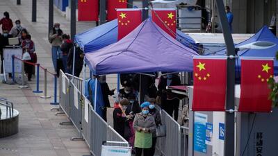 People line up to get tested for Covid-19 at a nucleic acid testing site in Shanghai, China, on Monday. (REUTERS)