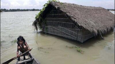 A flood affected girl rows a boat near her submerged house at Burhaburhi village, about 65 km east of Guwahati in Assam. (AP File Photo) A flood affected girl rows a boat near her submerged house at Burhaburhi village, about 65 km east of Guwahati in Assam. (AP File Photo)