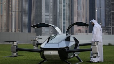 A man looks at the XPeng X2, an electric flying taxi developed by the Guangzhou-based XPeng, Inc's aviation affiliate, being tested in front of the Marina District in Dubai. (AP) A man looks at the XPeng X2, an electric flying taxi developed by the Guangzhou-based XPeng, Inc's aviation affiliate, being tested in front of the Marina District in Dubai. (AP)