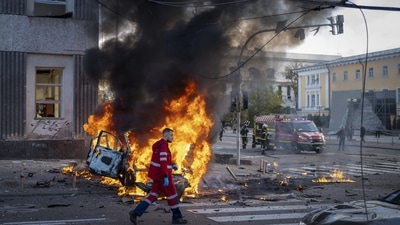 Russia-Ukraine War: A medical worker runs past a burning car after a Russian attack in Kyiv, Ukraine. (AP)