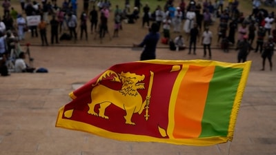 Sri Lanka Economic Crisis: A Sri Lankan flag is waved by a protester in Colombo, Sri Lanka. (AP)
