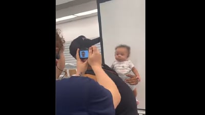 Man tries to take passport photo of baby. (Instagram/@babylolaadeleke) Man tries to take passport photo of baby. (Instagram/@babylolaadeleke)