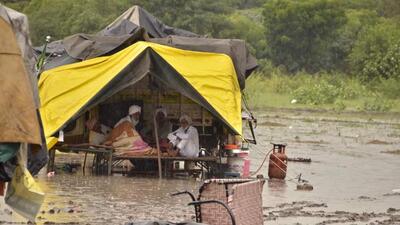 Farmers camping outside Punjab CM Bhagwant Mann’s Sangrur residence amid a downpour. (HT Photo)