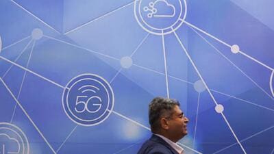 A man passes by a board board depicting 5G network at the ongoing India Mobile Congress 2022, at Pragati Maidan, in New Delhi, India, October 3, 2022. (REUTERS) A man passes by a board board depicting 5G network at the ongoing India Mobile Congress 2022, at Pragati Maidan, in New Delhi, India, October 3, 2022. (REUTERS)