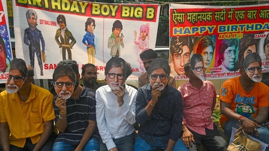 Fans wear masks in the guise of Amitabh Bachchan as they wait outside his house on the occasion of his 80th birthday in Mumbai on October 11, 2022. (Photo by INDRANIL MUKHERJEE / AFP)(AFP)