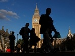 Pedestrians walk plast the Elizabeth Tower, more commonly known as Big Ben for the bell inside the tower's clock, at the the Houses of Parliament in central London. The British government on Monday brought forward key economic forecasts to Halloween, hoping not to spook markets further. London in UK attracts American tourists, despite inflation, amid weak pound.(Photo by CARLOS JASSO / AFP) Pedestrians walk plast the Elizabeth Tower, more commonly known as Big Ben for the bell inside the tower's clock, at the the Houses of Parliament in central London. The British government on Monday brought forward key economic forecasts to Halloween, hoping not to spook markets further. London in UK attracts American tourists, despite inflation, amid weak pound.(Photo by CARLOS JASSO / AFP)