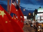 China-Taiwan Conflict: Flags of China and Taiwan flutter next to each other during a rally in Taipei, Taiwan. China-Taiwan Conflict: Flags of China and Taiwan flutter next to each other during a rally in Taipei, Taiwan.