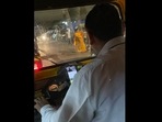 The image shows the Uber driver studing in his auto to help her daughter prepare for UPSC. The image shows the Uber driver studing in his auto to help her daughter prepare for UPSC. 