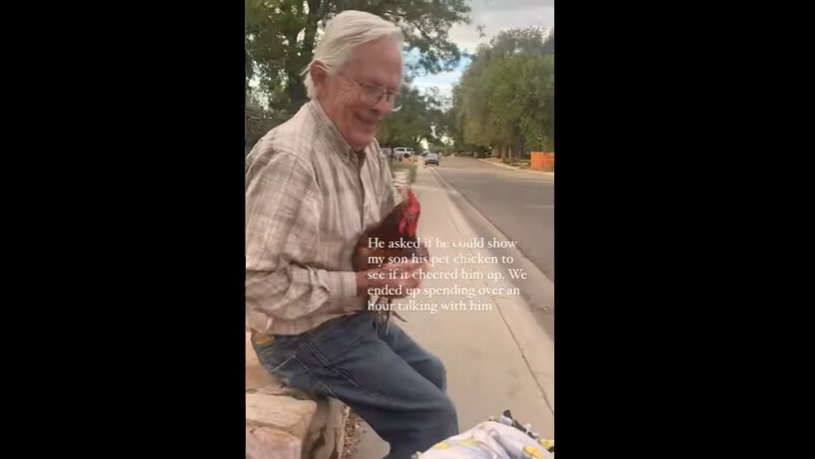 Old man cheers up toddler with his pet chicken. Watch wholesome video