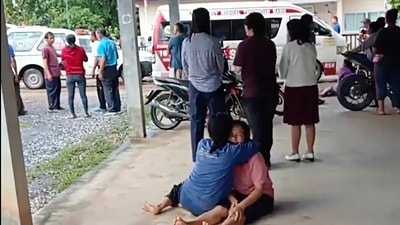 Thailand Daycare Centre Shooting: A distraught woman is comforted outside the site of an attack at a daycare canter, (AP) Thailand Daycare Centre Shooting: A distraught woman is comforted outside the site of an attack at a daycare canter, (AP)
