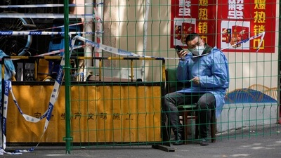 Covid In Shanghai: A worker in a protective suit in Shanghai, China. (Reuters)