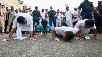 Rahul Gandhi doing push-ups in a challenge with DK Shivakumar, KC Venugopal and a boy in Karnataka during Bharat Jodo Yatra.&nbsp;