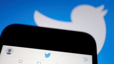 Twitter: Twitter app is displayed on a mobile phone near a Twitter logo. (Reuters)