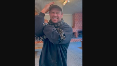 The image, taken from the video Instagram video, shows Chris Hemsworth with a snake wrapped around his neck. (Instagram/@chrishemsworth)