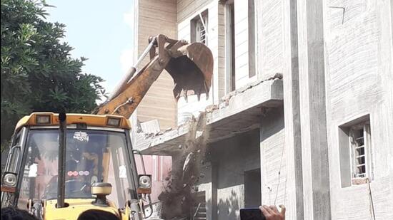 Two ‘illegal’ structures belonging to alleged drug peddlers Rajesh and Ajay were demolished by a joint team in the Yamunanagar’s Radaur block on Wednesday. (HT Photo)