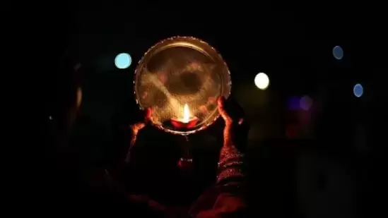 Women break the Karwa Chauth vrat after sighting the moon.