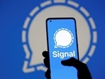 The Signal messaging app logo is seen on a smartphone, in front of the same displayed same logo, in this illustration taken in 2021.(REUTERS)