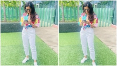 Keerthy teamed her shirt with a pair of high-waisted white trousers and white sneakers. (Instagram/@keerthysureshofficial)