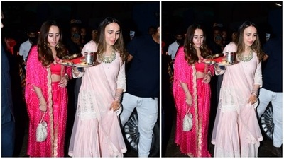 Varun Dhawan's wife Natasha Dalal donned a pink pants set that comprises of a crop top, pants and a cape. She accessorised her look with a potli. (HT Photo/Varinder Chawla) Varun Dhawan's wife Natasha Dalal donned a pink pants set that comprises of a crop top, pants and a cape. She accessorised her look with a potli. (HT Photo/Varinder Chawla)