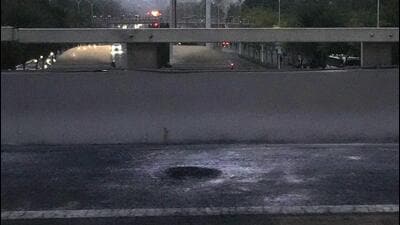 Scorched pavement is seen on the side of a highway overpass near the site where social media videos earlier appeared to show smoke and protest banners in Beijing, on Thursday. (AP) Scorched pavement is seen on the side of a highway overpass near the site where social media videos earlier appeared to show smoke and protest banners in Beijing, on Thursday. (AP)