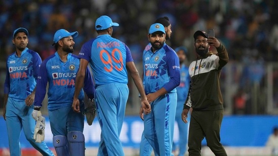 A fan manages to enter the field and takes a selfie with India's Rohit Sharma during the first Twenty20 cricket match between India and South Africa(AP)