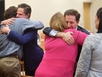 Plaintiff William Sherlach hugs attorney Josh Koskoff while plaintiff Nicole Hockley hugs attorney Chris Mattei following the jury verdict and reading of monetary damages in the Alex Jones defamation trial in Connecticut, US on October 12.(Reuters)