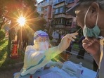A health worker takes a swab sample from a man to be tested for the Covid-19 coronavirus in China's northern Tianjin, August 31. (AFP) A health worker takes a swab sample from a man to be tested for the Covid-19 coronavirus in China's northern Tianjin, August 31. (AFP)