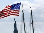 US Tourist Visa: United States flag flies near the Statue of Liberty in New York. US Tourist Visa: United States flag flies near the Statue of Liberty in New York.