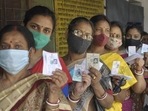 Women show their voter ID cards as they stand in a queue to cast their vote at a polling station. (PTI file.) Women show their voter ID cards as they stand in a queue to cast their vote at a polling station. (PTI file.)
