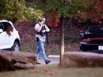 Law enforcement officer walks at the entrance to Neuse River Greenway Trail parking at Abington Lane following a shooting in Raleigh, North Carolina, Thursday, October 13, 2022. (Ethan Hyman/The News & Observer via AP) Law enforcement officer walks at the entrance to Neuse River Greenway Trail parking at Abington Lane following a shooting in Raleigh, North Carolina, Thursday, October 13, 2022. (Ethan Hyman/The News & Observer via AP)